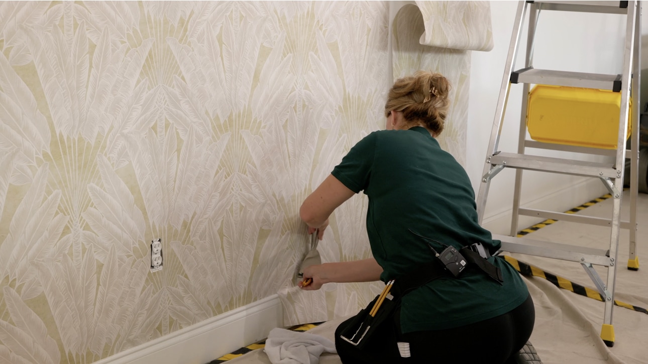 Finished light textured wallpaper wall in a bedroom