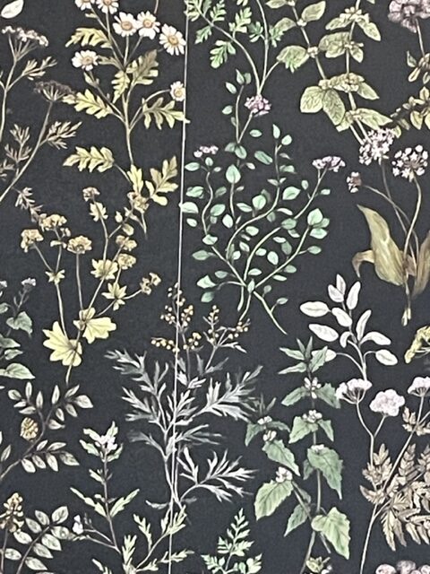 Wallpaper installer carefully working on a wall